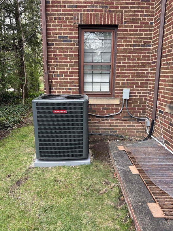 Completed Unico air handler swap-out with successful installation and system commissioning. New Goodman condensing unit installed on exterior concrete pad with proper refrigerant line routing and electrical connections established. System operational with supply air temperature verified at 56.3°F, confirming proper cooling performance and equipment functionality.