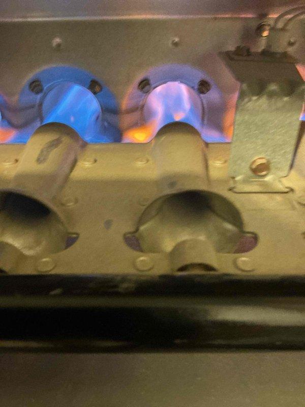 Completed comprehensive heating and cooling maintenance on two HVAC systems. Performed thorough inspection of gas furnace burner assemblies, confirmed proper flame characteristics with blue inner cones indicating efficient combustion, verified burner operation and ignition sequence, and documented system conditions through photographic records for quality assurance purposes.