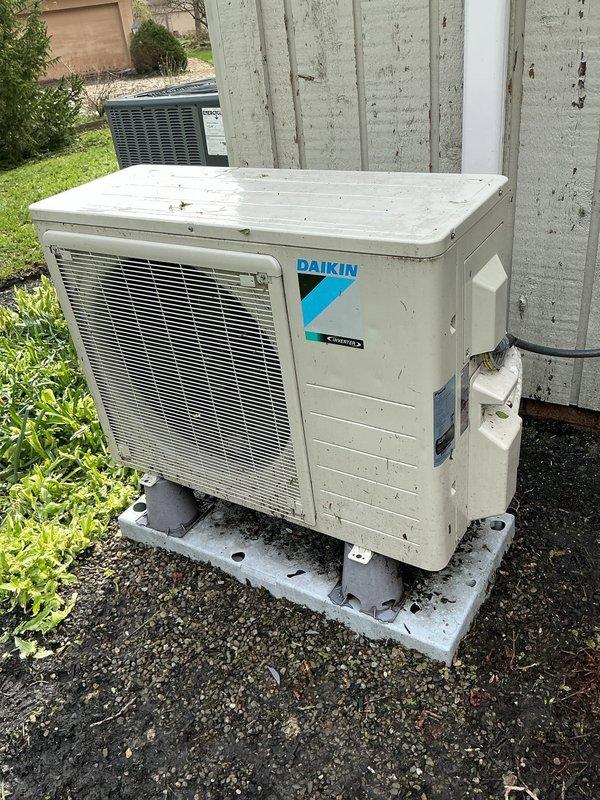 Performed post-storm inspection of residential Daikin air conditioning system at customer's request. Conducted thorough visual examination of outdoor condensing unit, mounting pad, electrical connections, and refrigerant lines for weather-related damage. Unit showed normal wear and weathering but no storm damage detected; system operational and secure on concrete pad.