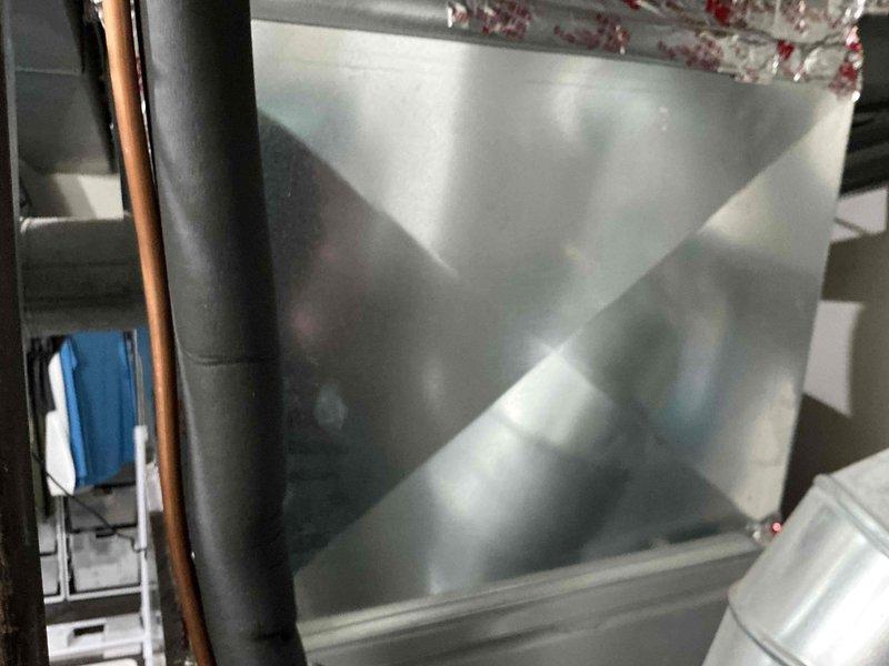 Completed HVAC system evaluation for replacement options on residential property. Assessment included indoor air handler unit located in attic space with existing refrigerant lines and ductwork, as well as outdoor condenser unit currently positioned on compromised ground where tree root growth is affecting equipment stability. Provided customer with comprehensive replacement estimates while noting that repair options remain viable alternatives, and recommended relocating condenser unit away from tree root to prevent future foundation and operational issues.