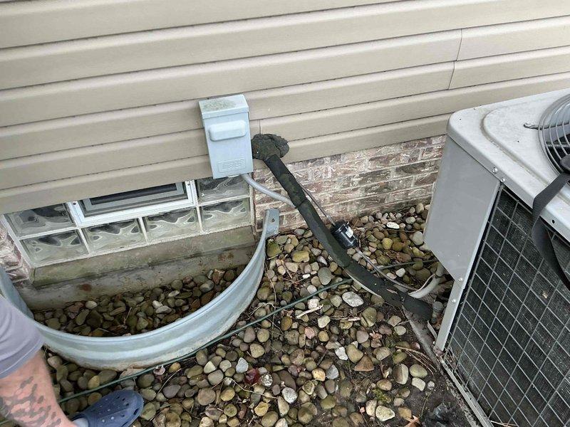 Completed HVAC system evaluation for replacement options on residential property. Assessment included indoor air handler unit located in attic space with existing refrigerant lines and ductwork, as well as outdoor condenser unit currently positioned on compromised ground where tree root growth is affecting equipment stability. Provided customer with comprehensive replacement estimates while noting that repair options remain viable alternatives, and recommended relocating condenser unit away from tree root to prevent future foundation and operational issues.