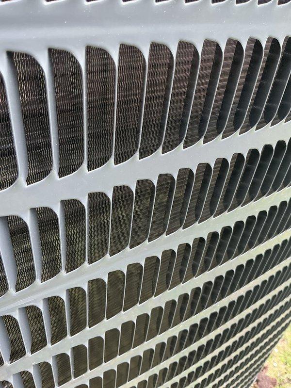 Responded to service call for newly installed Unico system experiencing intermittent cooling operation with repeated shutdowns. Performed diagnostic inspection of outdoor condensing unit and internal components, verified condenser coil condition and airflow pathways were clear and unobstructed. System components appeared properly installed with no visible damage to coils or protective grilles.