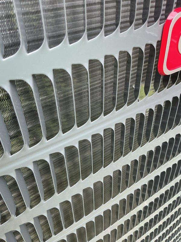 Responded to service call for newly installed Unico system experiencing intermittent cooling operation with repeated shutdowns. Performed diagnostic inspection of outdoor condensing unit and internal components, verified condenser coil condition and airflow pathways were clear and unobstructed. System components appeared properly installed with no visible damage to coils or protective grilles.