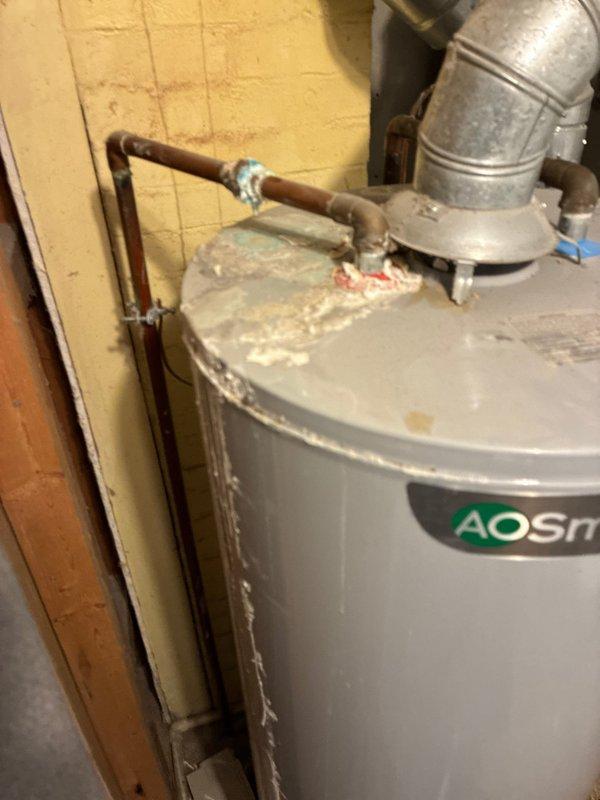 Conducted on-site evaluation for furnace replacement options. Inspected existing electrical panel configuration and documented current water heater condition, noting significant corrosion and deterioration on tank surfaces requiring consideration for comprehensive HVAC system upgrade planning.