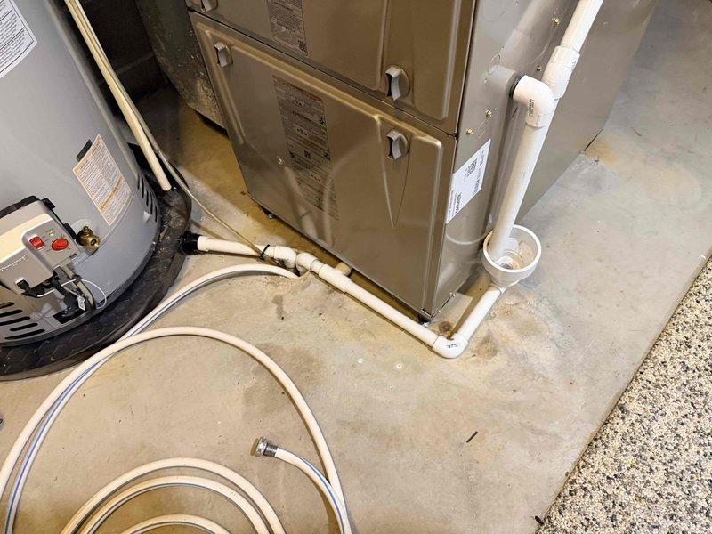 Installed Aprilaire E100 whole-home dehumidifier as a stand-alone, non-ducted unit in finished basement. Unit was positioned in suitable location outside furnace closet with dedicated 115VAC circuit run approximately 30 feet from existing Siemens electrical panel. Completed all necessary electrical connections, condensate drainage piping with PVC, and mounted unit to concrete block wall. Verified proper operation of digital control panel and tested unit functionality. Coordinated scheduling for required electrical and plumbing inspections per local code requirements.