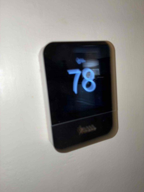 Responded to no cooling complaint on residential air conditioning system. Upon arrival, customer reported unit not producing cool air. Performed diagnostic inspection of HVAC control system and thermostat operation. Examined control board, wiring connections, and electrical components within the air handler enclosure. Verified all wire terminations at terminal blocks were secure and properly connected. Inspected PCB for any visible signs of failure or component damage. Checked thermostat display showing 78°F setpoint and confirmed communication between thermostat and system controls. All safety labels and warning indicators were noted to be present and legible on equipment.