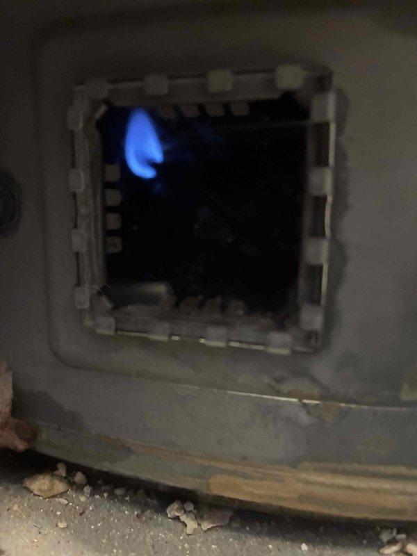 Responded to no hot water call and performed diagnostic inspection of tanked water heater. Upon examination, found evidence of significant internal corrosion, mineral deposits, and water leakage at the base of the unit around copper supply line connections, indicating tank failure. Verified gas burner assembly was operational with proper flame characteristics. Due to extensive rust damage and compromised tank integrity, recommended and completed full water heater replacement to restore hot water service.