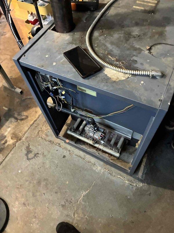 # HVAC Boiler Heating Maintenance

Performed comprehensive heating maintenance on boiler system located in mechanical room. Inspected primary boiler unit, a blue metal cabinet-style heating system with associated motorized components and control assemblies. Examined actuator motor assembly manufactured in Taiwan (Model C20 B2) mounted on bracket with proper hardware connections. Verified electrical connections and wiring integrity throughout system, including control circuits and power supply connections. Checked flexible metal vent connector for proper installation and secure attachment. Assessed overall system operation and component condition. Unit showed normal wear patterns consistent with regular operation. All mechanical and electrical components functioning within normal parameters at time of inspection.