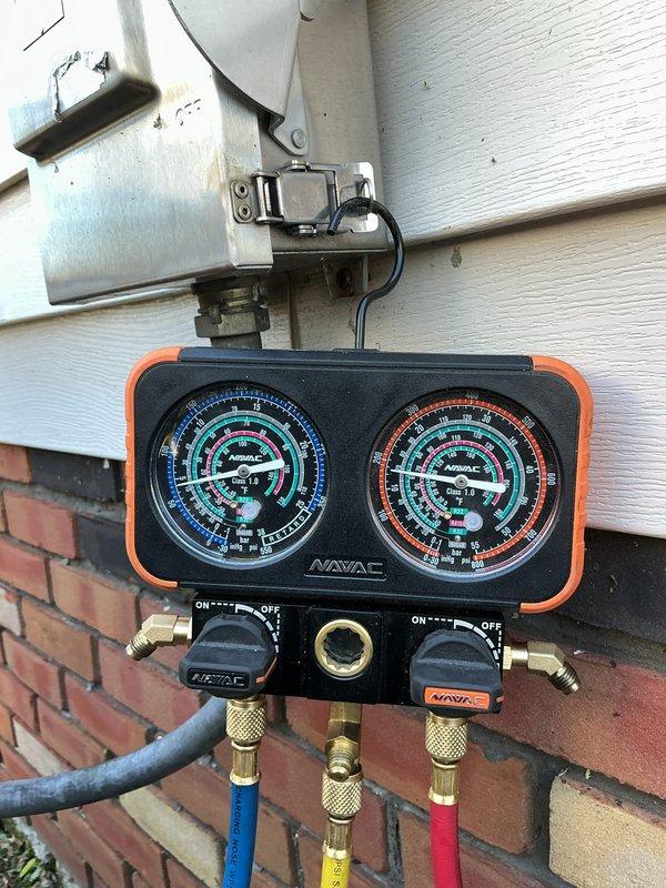 Completed compressor replacement on outdoor condensing unit under warranty coverage. Performed system diagnostics using manifold gauges to verify proper refrigerant pressures and confirm successful compressor installation and operation.
