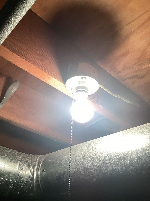 Conducted on-site assessment for installation of two light fixtures in basement area. Evaluated existing ceiling structure with exposed wooden beams and joists to determine optimal mounting locations and electrical routing. Documented current conditions including one existing ceiling fan with light fixture and one single-bulb ceiling-mounted fixture, both with pull-chain operation. Assessed proximity to large metallic HVAC ductwork running horizontally through the space to ensure proper clearance for new fixture installations. Inspected electrical access points and determined feasibility for extending circuits to accommodate additional lighting fixtures. Provided comprehensive estimate for labor and materials required to complete the installation work.