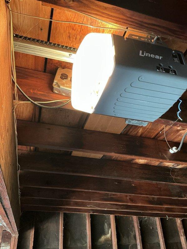 Returned to address garage door opener issue from previous service visit. Inspected Linear brand garage door opener installation, verified proper mounting to ceiling joists, and checked electrical connections and wiring routing. Tested opener operation and manual release mechanism to ensure system functioning correctly. Resolved previous concern and confirmed garage door opener operating as intended.