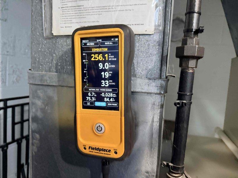# Heating System and Hot Water Tank Maintenance

Performed comprehensive seasonal maintenance on residential heating system and hot water tank. Conducted complete combustion analysis using calibrated analyzer, measuring flue gas temperature at 256.1°F with CO readings at 9 ppm and oxygen levels at 9.0%, confirming efficient and safe burner operation within manufacturer specifications. 

Inspected burner assembly, heat exchanger, and all combustion chamber components for proper operation and signs of wear. Verified gas pressure, flame characteristics, and ignition sequence. Examined all electrical connections, wiring harnesses, and control circuits for secure connections and proper voltage. Inspected copper refrigerant lines and condensate drainage system for leaks or deterioration. 

Reviewed manufacturer operating instructions and safety documentation posted on unit. Completed hot water tank inspection including temperature and pressure relief valve testing, anode rod assessment, and 