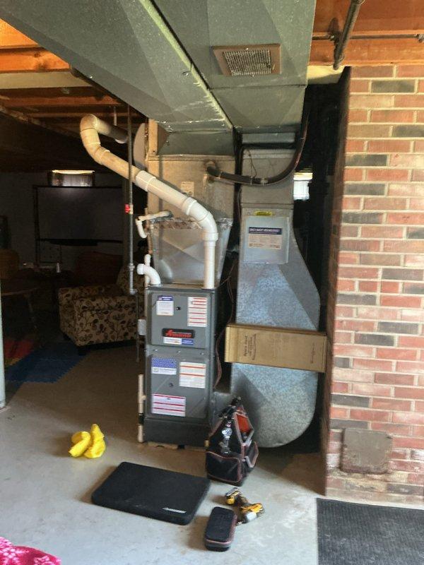 Completed first-year heating maintenance on residential furnace system in basement utility area. Performed comprehensive inspection of furnace unit, ductwork connections, PVC venting system, and associated components to ensure proper operation and safety compliance. All equipment found to be functioning within normal parameters with no immediate service needs identified.