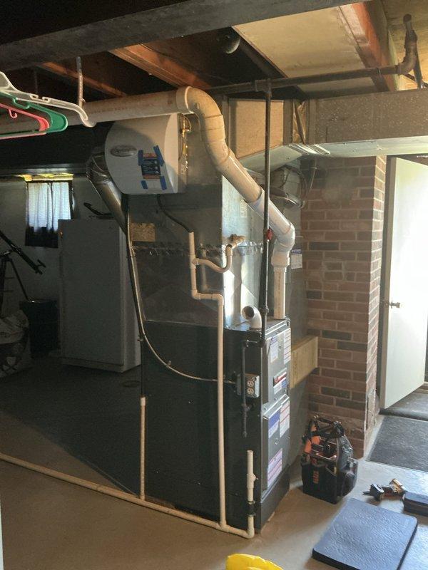 Completed first-year heating maintenance on residential furnace system in basement utility area. Performed comprehensive inspection of furnace unit, ductwork connections, PVC venting system, and associated components to ensure proper operation and safety compliance. All equipment found to be functioning within normal parameters with no immediate service needs identified.