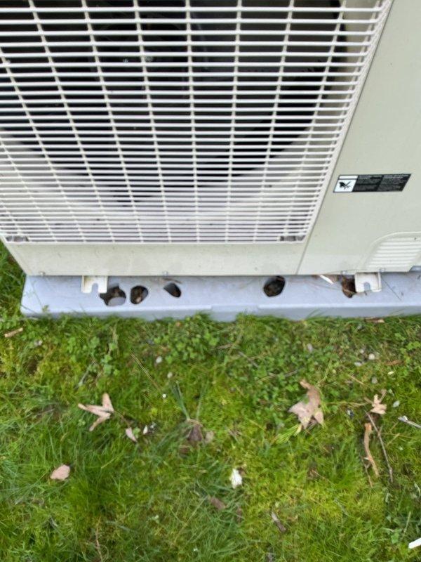 Completed cooling system tune-up on outdoor heat pump unit and documented hail damage to equipment casing and protective grille for estimate purposes. Unit operational following preventive maintenance inspection, with photographic documentation provided to customer for insurance claim processing.