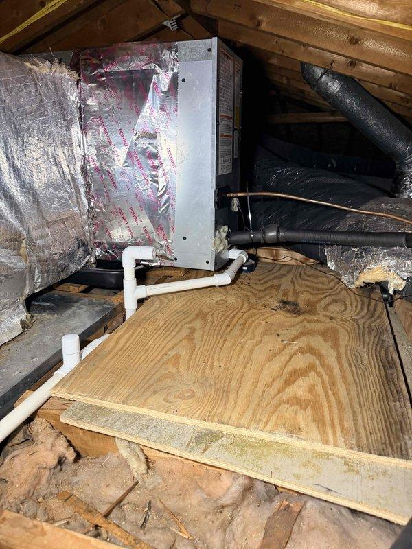 Responded to no cooling complaint on 7-month-old air handler unit installed in attic. Upon arrival, verified system was not operating when thermostat was set to cool with fan in auto mode. Performed diagnostic inspection of air handler unit, checked electrical connections, verified power supply, and inspected condensate drainage system. Documented equipment condition and attic installation with photographs showing unit placement, ductwork configuration, and insulation material.