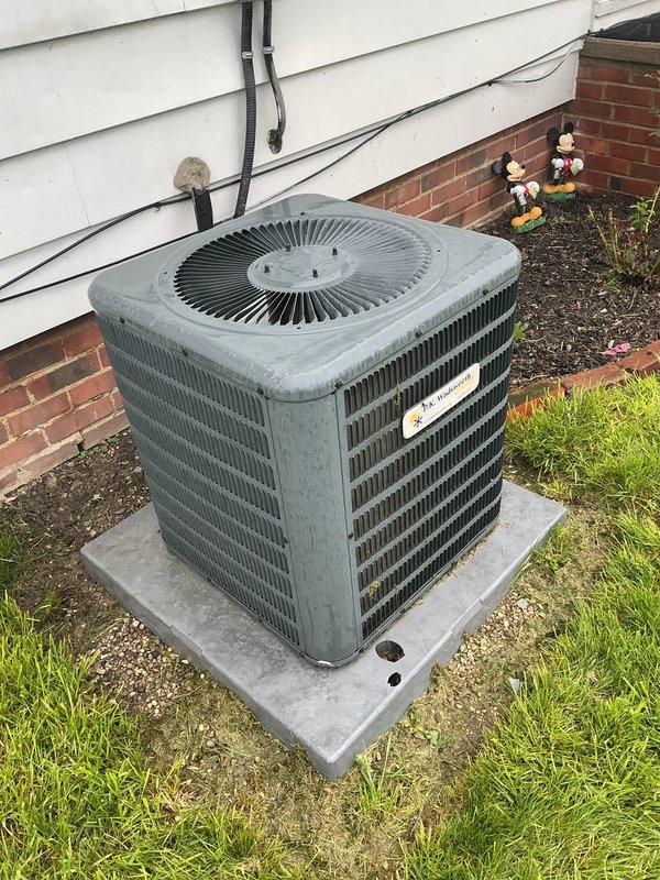 Responded to service call for AC unit inspection following storm damage to equipment and concrete pad. Performed thorough visual assessment of outdoor condenser unit and surrounding installation. Inspected condenser coils, fan assembly, cabinet integrity, electrical conduit, and refrigerant lines for storm-related damage. Verified concrete pad stability and levelness. Documented equipment condition with photographs showing unit operational status, exterior housing, fan grille assembly, and mounting configuration. Unit showed normal weathering consistent with age but no visible storm damage to critical components. Electrical connections and conduit routing intact with no signs of impact or displacement.