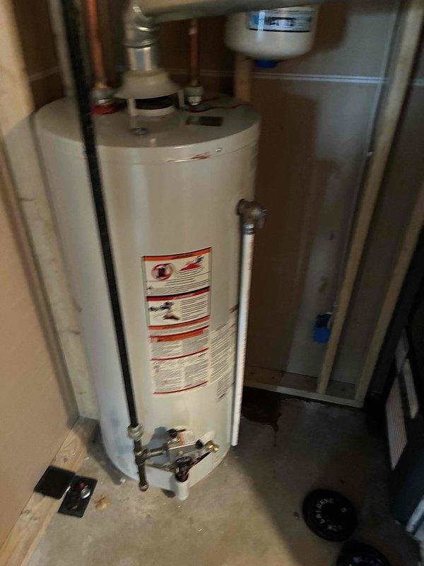 Performed routine maintenance on residential tanked water heater system. Inspected all plumbing connections, copper supply lines, and shut-off valves for proper operation and signs of wear. Verified expansion tank mounting and pressure settings, examined gas line connections and safety controls, and assessed overall unit condition including checking for rust or corrosion on tank exterior.