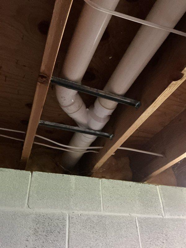 Responded to follow-up no heat call where previous technician had visited. Accessed HVAC system in basement utility area and inspected blower assembly and motor components. Verified all electrical connections at blower motor terminals, checked wire integrity including red, yellow, orange, and white conductor connections, and confirmed proper motor mounting and mechanical operation. System evaluated and documented with photos showing blower assembly and basement infrastructure access point.