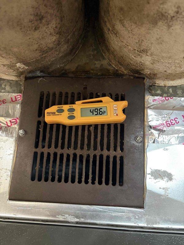 Completed full HVAC system installation including 96% high-efficiency furnace, air conditioning unit, and ductwork with insulated liner. System commissioning verified proper airflow with supply air temperature of 43.6°F and return air temperature of 71.2°F, confirming adequate cooling capacity and temperature differential. All components tested and operational, with condensation on evaporator coil indicating normal system function.