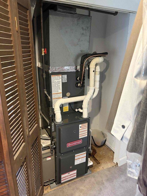 Completed installation of new Goodman 96% AFUE furnace with matching air conditioning system in interior closet location. Installed furnace vertically with evaporator coil positioned above unit to maximize space efficiency in confined area. Ran white PVC condensate and vent piping from equipment with proper routing and support. Performed system startup, verified proper airflow, and conducted operational testing with Fieldpiece diagnostic instruments to confirm refrigerant charge and system performance within manufacturer specifications.
