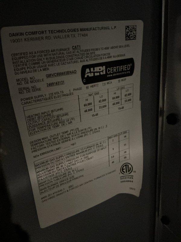 Completed first-year HVAC heating maintenance on a Daikin forced air furnace, model GMVC800603BNAD, with 60,000 BTU/HR input capacity certified for natural gas operation. Performed comprehensive system inspection, verified all mechanical and electrical components were functioning within manufacturer specifications, and documented equipment condition with photos of the unit's specification label and associated water heater plumbing connections in the mechanical room.