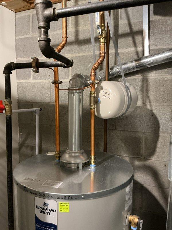 Completed first-year HVAC heating maintenance on a Daikin forced air furnace, model GMVC800603BNAD, with 60,000 BTU/HR input capacity certified for natural gas operation. Performed comprehensive system inspection, verified all mechanical and electrical components were functioning within manufacturer specifications, and documented equipment condition with photos of the unit's specification label and associated water heater plumbing connections in the mechanical room.