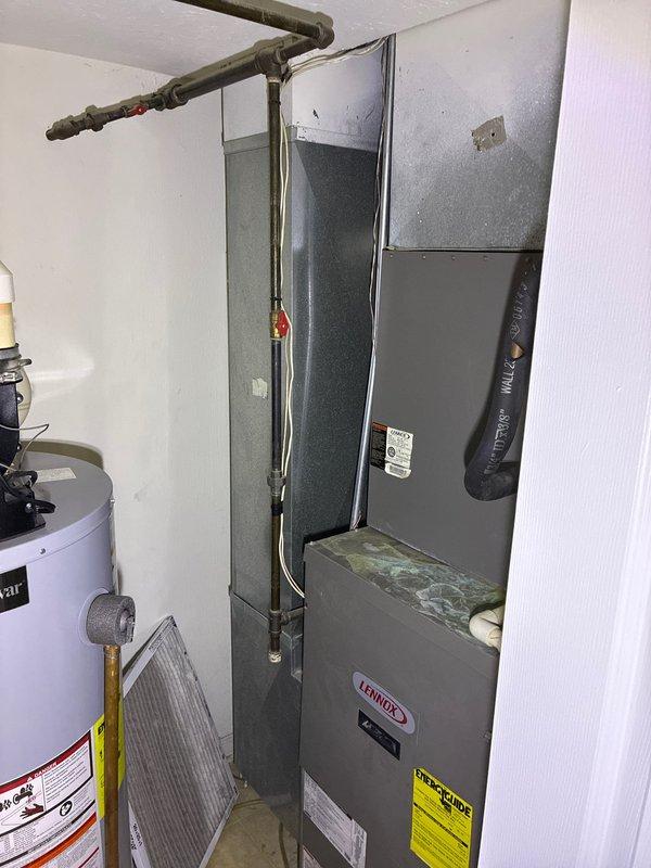 Conducted comprehensive assessment of existing Lennox furnace and air conditioning system to provide replacement options. Evaluated current HVAC equipment condition, ductwork configuration, and refrigerant line setup in basement utility area. Documented existing system components including furnace unit, evaporator coil assembly, condensate drain system with visible mineral deposits and algae buildup indicating drainage concerns, and refrigerant line insulation. Photographed equipment specifications and installation details to develop accurate replacement estimate. Presented homeowner with multiple replacement options including full system changeout recommendations based on equipment age and observed condensate pan deterioration. Contacted property owner remotely upon completion of assessment as requested.
