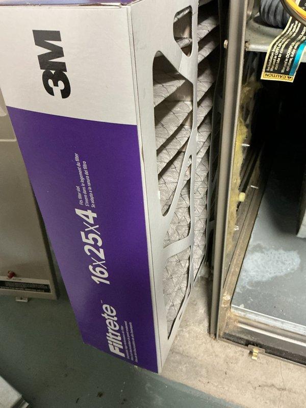 Completed afternoon heating maintenance and added new equipment to the system. Installed 3M Filtrete air filter (17.5x19) in the furnace unit, ensuring proper fit and airflow for optimal system performance. Documented existing HVAC equipment including the white furnace with accessible filter panel and water heater with expansion tank in the mechanical room.