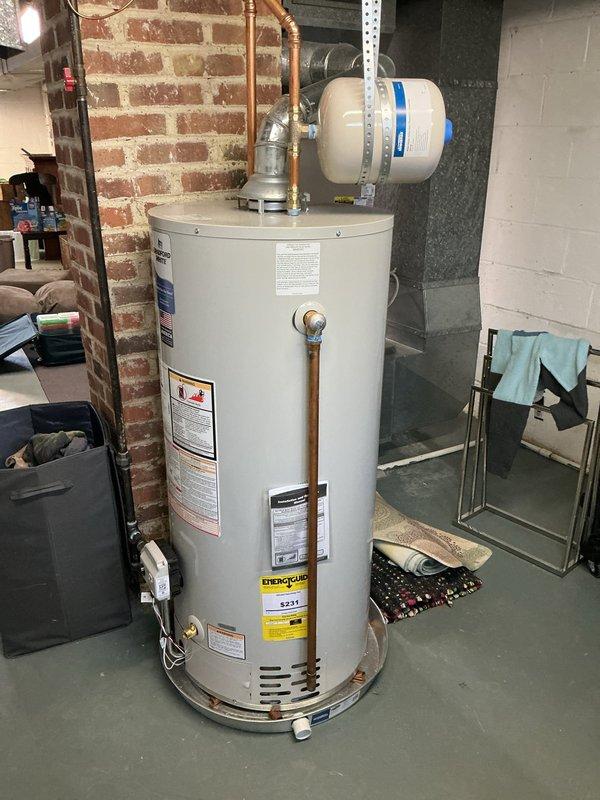 Completed afternoon heating maintenance and added new equipment to the system. Installed 3M Filtrete air filter (17.5x19) in the furnace unit, ensuring proper fit and airflow for optimal system performance. Documented existing HVAC equipment including the white furnace with accessible filter panel and water heater with expansion tank in the mechanical room.