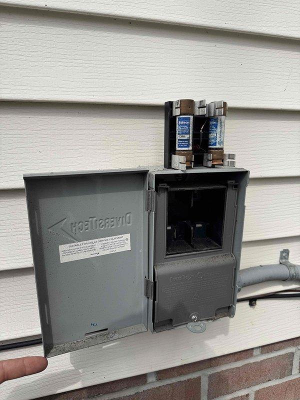 Completed HVAC cooling maintenance tune-up on residential system. Inspected outdoor disconnect box and fuses, verified electrical connections and conduit routing, and examined condensing unit installation at exterior location. All components found in normal working condition with system ready for cooling season operation.