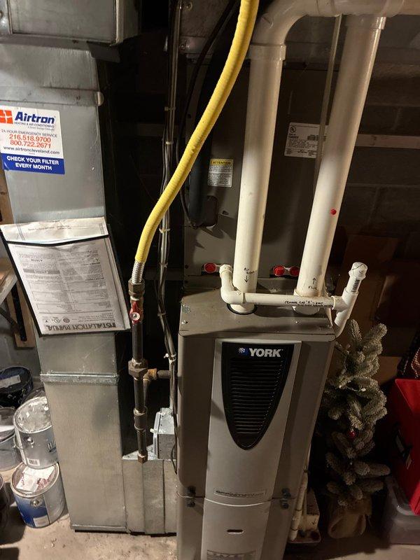Completed HVAC system estimate and assessment for equipment replacement in residential basement installation. Evaluated existing Airtron air handler unit and York HVAC components, documenting current system configuration including PVC condensate drain lines, flexible ductwork connections, and overall equipment condition to provide replacement options for homeowner consideration.