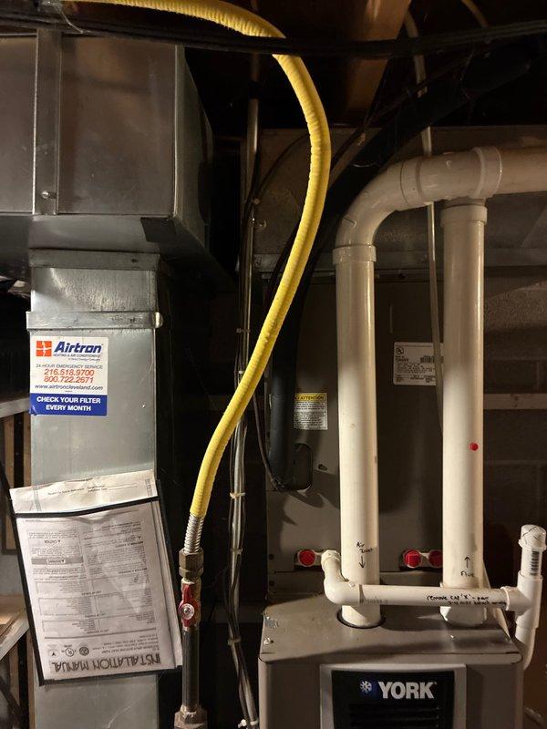 Completed HVAC system estimate and assessment for equipment replacement in residential basement installation. Evaluated existing Airtron air handler unit and York HVAC components, documenting current system configuration including PVC condensate drain lines, flexible ductwork connections, and overall equipment condition to provide replacement options for homeowner consideration.