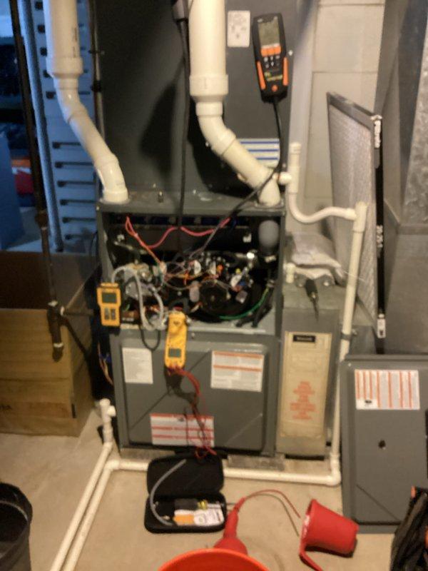 Completed comprehensive HVAC heating and cooling maintenance on residential furnace and air conditioning system. Performed diagnostic testing using digital multimeters and temperature probes to verify proper electrical readings, airflow measurements, and system performance parameters. Inspected internal furnace components including blower motor, wiring connections, and mechanical assemblies with access panel removed for thorough evaluation of all operational systems.