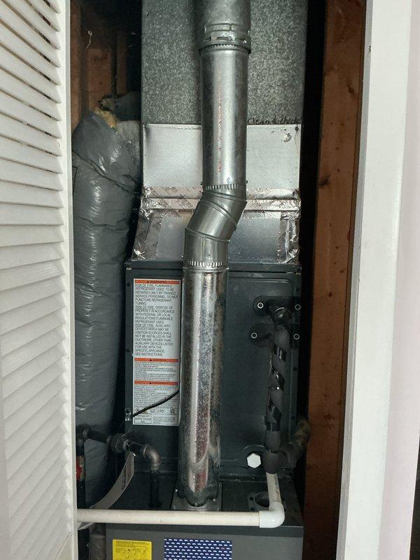 # HVAC Maintenance Service Completed

Performed comprehensive annual preventive maintenance on residential split-system air conditioning equipment as part of scheduled service plan agreement. 

**Outdoor Unit Inspection:**
Conducted thorough inspection of Amana brand condenser unit located on exterior concrete pad. Verified proper operation of condenser fan motor and assessed overall unit condition. Inspected electrical disconnect boxes and conduit connections for secure mounting and proper weatherproofing. Noted accumulation of organic debris, moss growth, and weathering on concrete pad and surrounding area. Cleared debris from base of unit and immediate perimeter to ensure adequate airflow and prevent potential blockages to coil surfaces.

**Indoor Unit Inspection:**
Accessed furnace and air handler equipment in mechanical closet. Inspected blower assembly, filter condition, and ductwork connections. Verified proper installation and condition of flexible supply ductwork with insulati