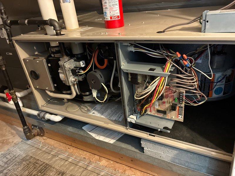 Evaluated existing HVAC system located in third-floor attic space for replacement options. Documented current gas furnace and air handler configuration, including internal components, blower assembly, control board wiring, and gas valve connections. Assessed exterior condensing unit disconnect and refrigerant line routing along building foundation to provide comprehensive replacement recommendations.