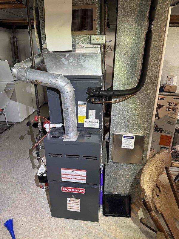 Completed comprehensive HVAC cooling and heating maintenance on dual-system Goodman residential installation located in basement utility area. Performed standard seasonal maintenance procedures including inspection of furnace unit, air handler, refrigerant lines, electrical connections, and ductwork throughout the system. All components were found to be operating within normal parameters, with ductwork and connections properly secured along brick wall routing and throughout the installation area.