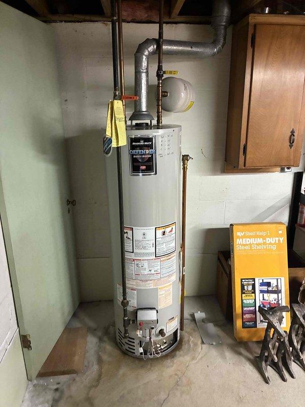 Responded to service call for reported water heater leak. Upon arrival, performed visual inspection of residential tanked water heater unit and surrounding plumbing connections. Documented existing installation configuration including copper supply lines, gas valve connections, expansion tank, and ventilation ductwork. Recorded unit specifications and measurements for service records. Collected diagnostic fee and photographed equipment condition for assessment purposes.