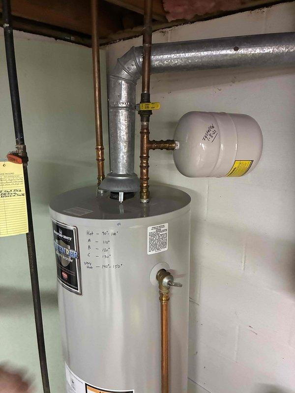 Responded to service call for reported water heater leak. Upon arrival, performed visual inspection of residential tanked water heater unit and surrounding plumbing connections. Documented existing installation configuration including copper supply lines, gas valve connections, expansion tank, and ventilation ductwork. Recorded unit specifications and measurements for service records. Collected diagnostic fee and photographed equipment condition for assessment purposes.