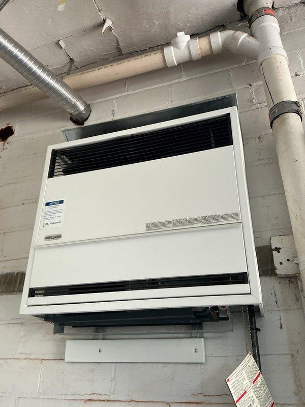 Performed comprehensive heating maintenance on two HVAC systems, including inspection of wall-mounted heating unit and boiler equipment. Documented corrosion observed on boiler glass and assessed overall system condition, with all findings photographed for service records.