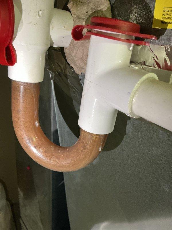 Completed comprehensive cooling system maintenance and performed full service on Rinnai tankless water heater unit. Inspected and verified proper operation of digital controls displaying 430°F setpoint, checked all plumbing connections including copper lines and shut-off valves with proper hot/cold identification, and examined P-trap assembly and drainage components beneath unit for proper function and leak-free operation.