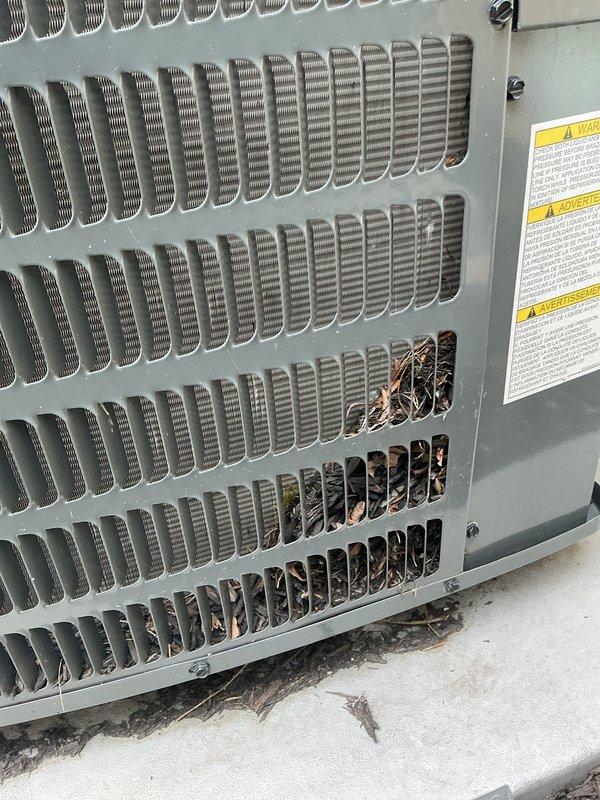 Completed preventive maintenance on two residential cooling systems as part of ongoing service agreement. Inspected indoor air handler unit located in attic space, verifying proper operation of blower assembly, condensate drain lines, and ductwork connections. Examined outdoor condensing unit, noting debris accumulation in lower louver sections including leaves and organic material. Cleared obstructions from condenser coil intake area to restore proper airflow and prevent reduced efficiency. Verified refrigerant levels, electrical connections, and safety controls on both systems. All equipment operating within normal parameters following service completion.