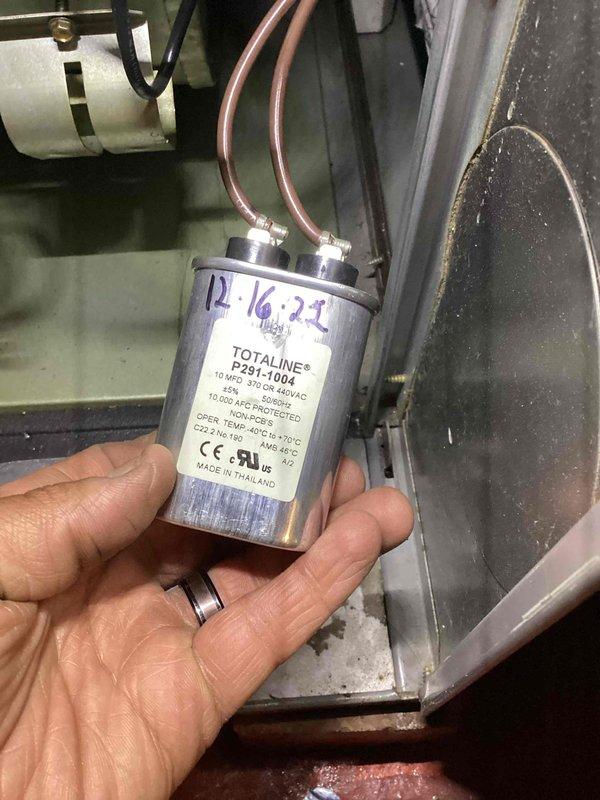 # HVAC Cooling System Maintenance - 10+ Years Old Unit

Performed comprehensive preventive maintenance on aging cooling system. Inspected and tested run capacitor (TOTALINE P291-1004, 10 MFD, 370/440 VAC), which showed previous service date marking from December 2022. Capacitor tested within acceptable parameters and remains in service. Conducted full system evaluation including blower motor operation, electrical connections, and control panel functionality. Verified proper drainage and condensate removal, with collection containers positioned to monitor system discharge. All internal components inspected for wear, wiring integrity confirmed, and safety controls verified operational. System running efficiently with no immediate repairs required at this time.
