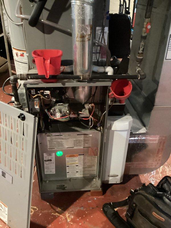 # HVAC Cooling System Maintenance - 10+ Years Old Unit

Performed comprehensive preventive maintenance on aging cooling system. Inspected and tested run capacitor (TOTALINE P291-1004, 10 MFD, 370/440 VAC), which showed previous service date marking from December 2022. Capacitor tested within acceptable parameters and remains in service. Conducted full system evaluation including blower motor operation, electrical connections, and control panel functionality. Verified proper drainage and condensate removal, with collection containers positioned to monitor system discharge. All internal components inspected for wear, wiring integrity confirmed, and safety controls verified operational. System running efficiently with no immediate repairs required at this time.
