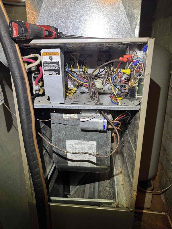 Completed comprehensive heating and cooling maintenance on two HVAC systems. Performed thorough inspection of air handler unit, including examination of blower motor assembly, electrical connections, and wiring harnesses with all terminals and wire nuts verified secure. Inspected water treatment system retention tank (Model RT80) rated at 75 PSIG maximum operating pressure, confirming proper installation and plumbing connections with PVC supply lines intact. All components found operating within manufacturer specifications with no deficiencies noted.