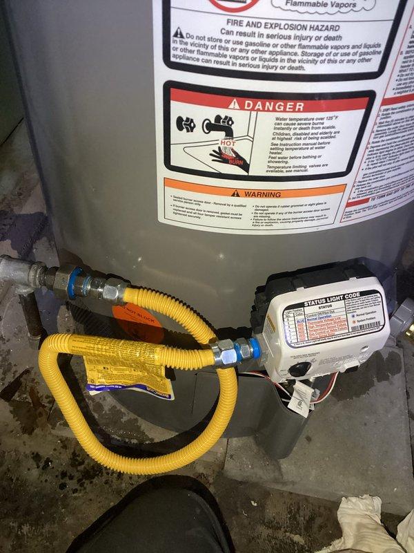 Completed scheduled maintenance flush and fill service on residential tanked water heater. Drained sediment buildup from tank bottom, flushed system with fresh water to remove mineral deposits and debris, and refilled unit to proper operating level. Inspected water heater components including flexible stainless steel braided supply lines with brass fittings, yellow corrugated gas line connections, electronic control unit, and safety labels for proper condition. Verified all plumbing connections, fittings, and shut-off valves were secure with no signs of leaks. System tested and confirmed operational following maintenance procedure.