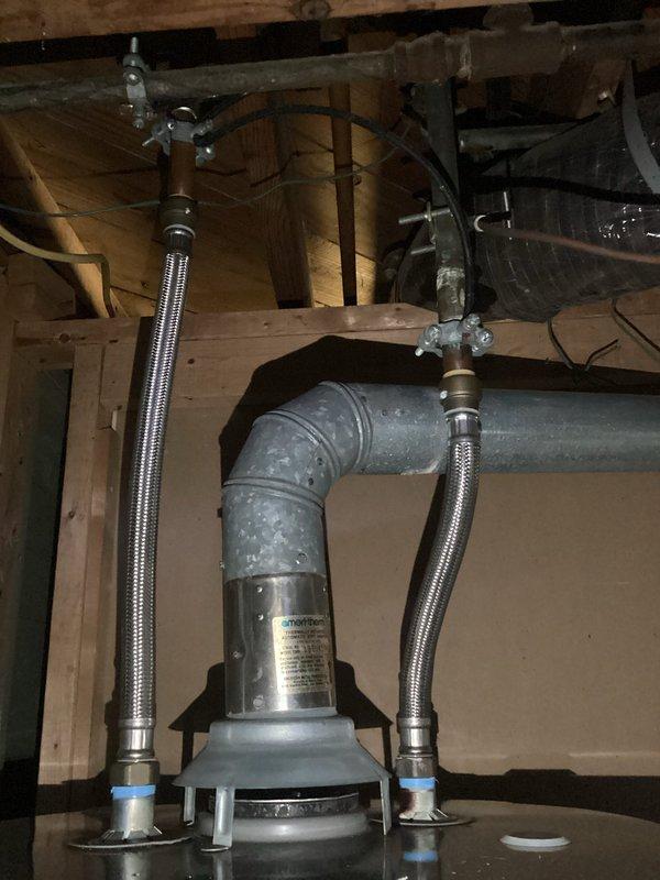 Completed scheduled maintenance flush and fill service on residential tanked water heater. Drained sediment buildup from tank bottom, flushed system with fresh water to remove mineral deposits and debris, and refilled unit to proper operating level. Inspected water heater components including flexible stainless steel braided supply lines with brass fittings, yellow corrugated gas line connections, electronic control unit, and safety labels for proper condition. Verified all plumbing connections, fittings, and shut-off valves were secure with no signs of leaks. System tested and confirmed operational following maintenance procedure.