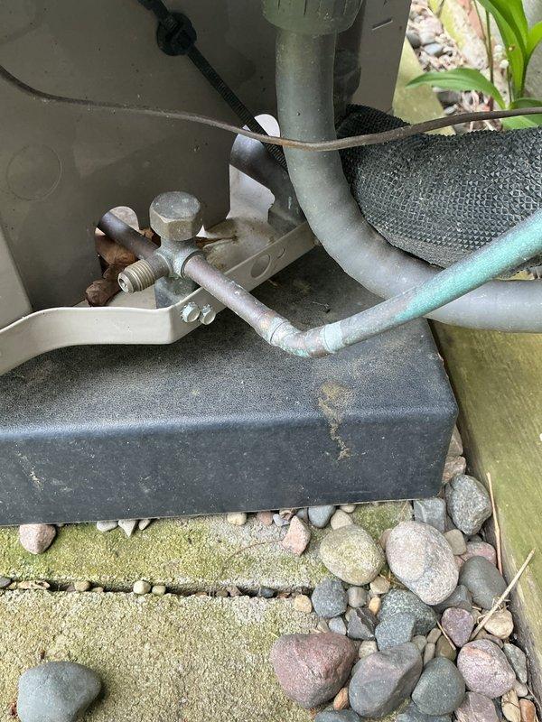 Completed scheduled cooling system maintenance on outdoor condensing unit and associated indoor components. Inspected Aprilaire humidifier installation, verified proper mounting and water supply line connection to ductwork system. Examined outdoor unit refrigerant lines, service valves, and connection points; noted normal weathering on exterior components with all piping properly secured and insulated.