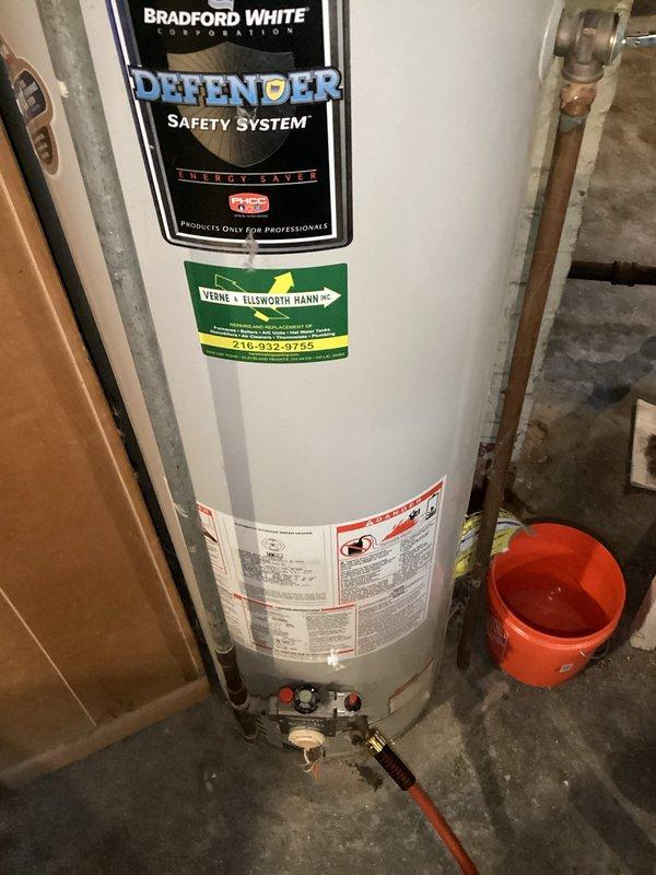 Performed routine maintenance flush on Bradford White Defender Safety System tanked water heater. Drained sediment from tank bottom via drain valve, inspected all connections and valves for proper operation, and verified gas line shut-off valves and plumbing connections remained secure and leak-free throughout the procedure.