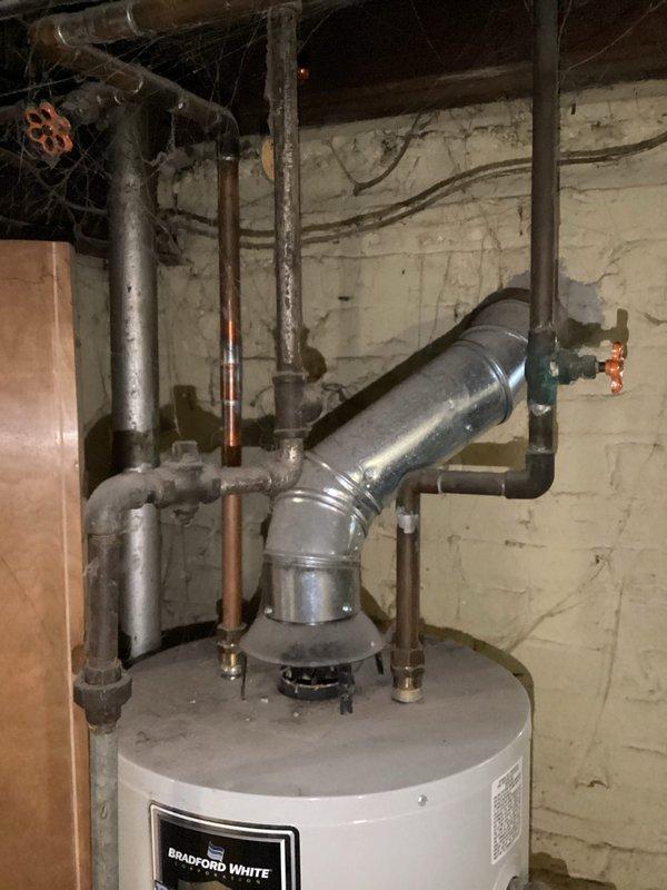 Performed routine maintenance flush on Bradford White Defender Safety System tanked water heater. Drained sediment from tank bottom via drain valve, inspected all connections and valves for proper operation, and verified gas line shut-off valves and plumbing connections remained secure and leak-free throughout the procedure.